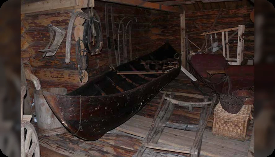 Долблёная лодка и снасти в хозяйственной постройке